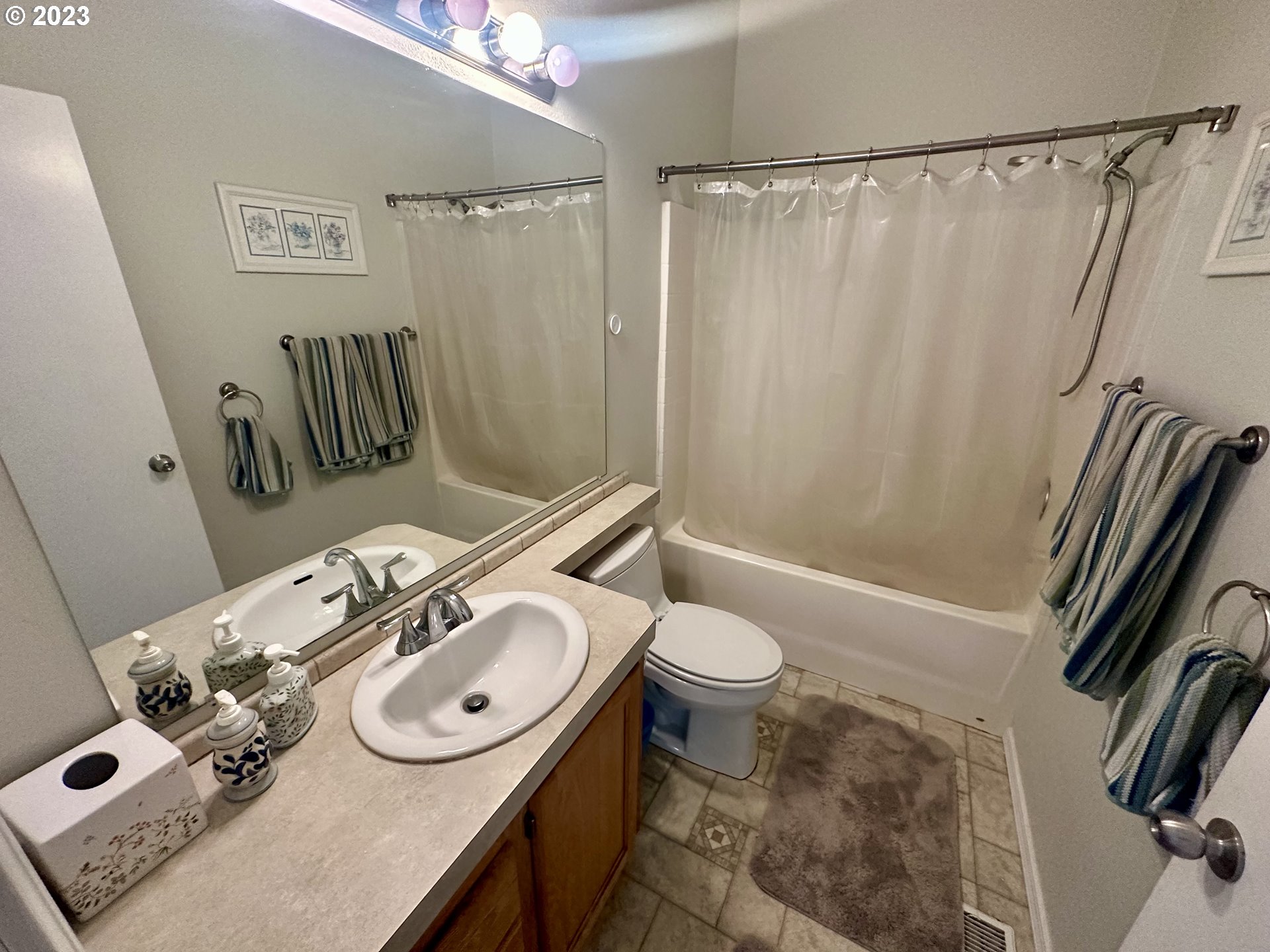5275 Bridgewater Drive Eugene, OR 97402 - Photo 16 of 18 a bathroom with a sink a toilet and shower curtain