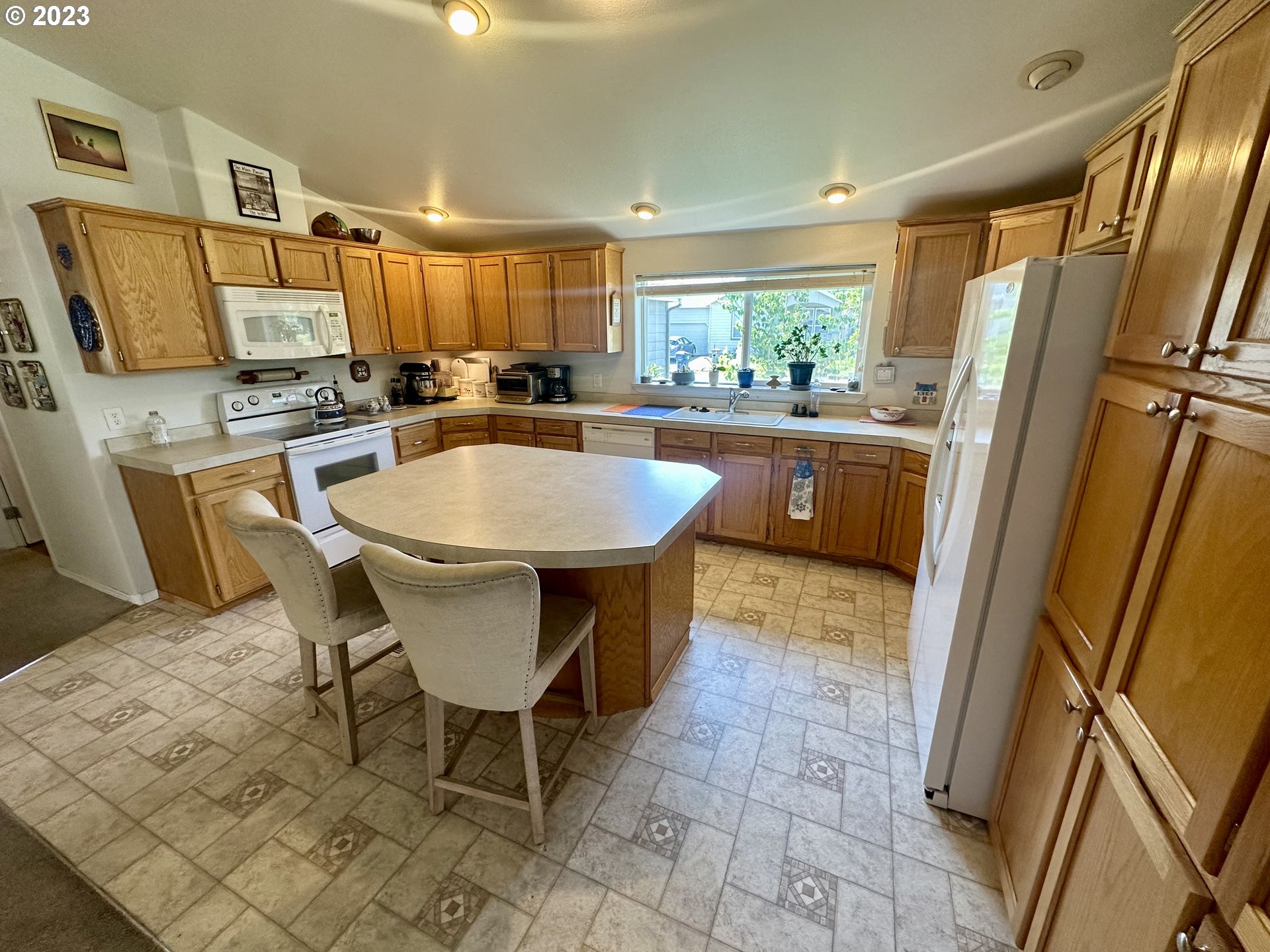 5275 Bridgewater Drive Eugene, OR 97402 - Photo 9 of 18 a kitchen with stainless steel appliances granite countertop a sink a counter space and a window