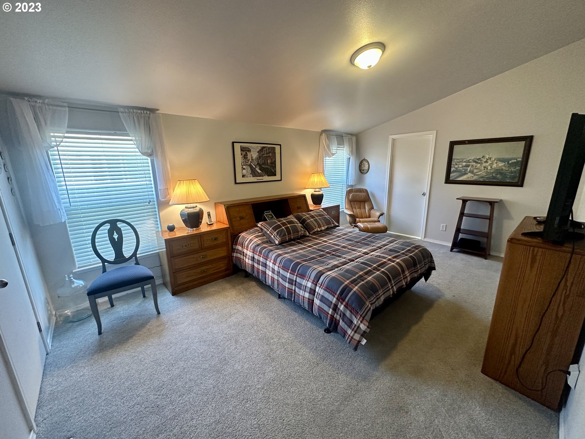 5275 Bridgewater Drive Eugene, OR 97402 - Photo 10 of 18 a bedroom with a bed and a chandelier