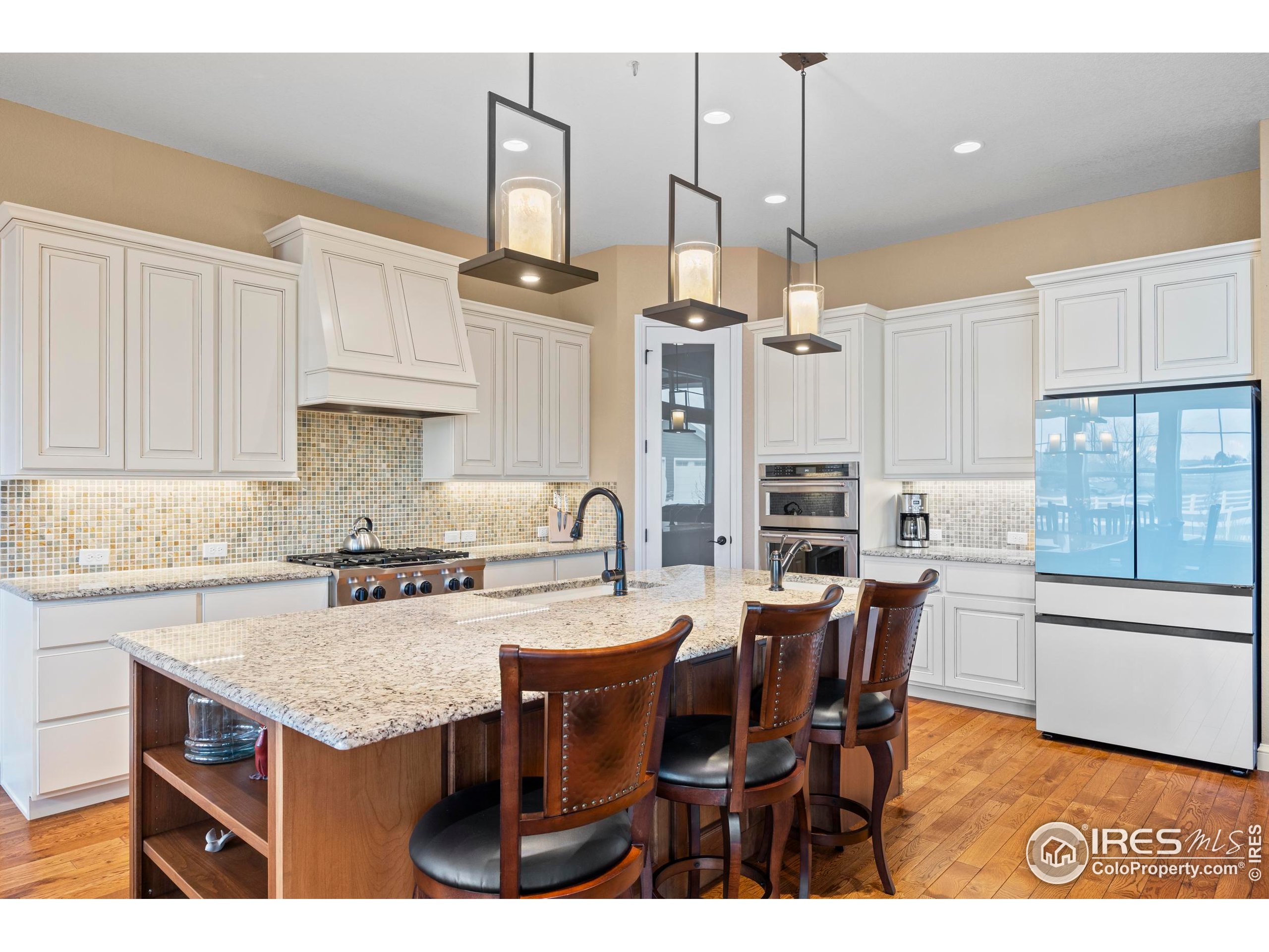 39884 Ridgecrest Court Severance, CO 80610 - Photo 13 of 44 a kitchen with cabinets appliances and a dining table