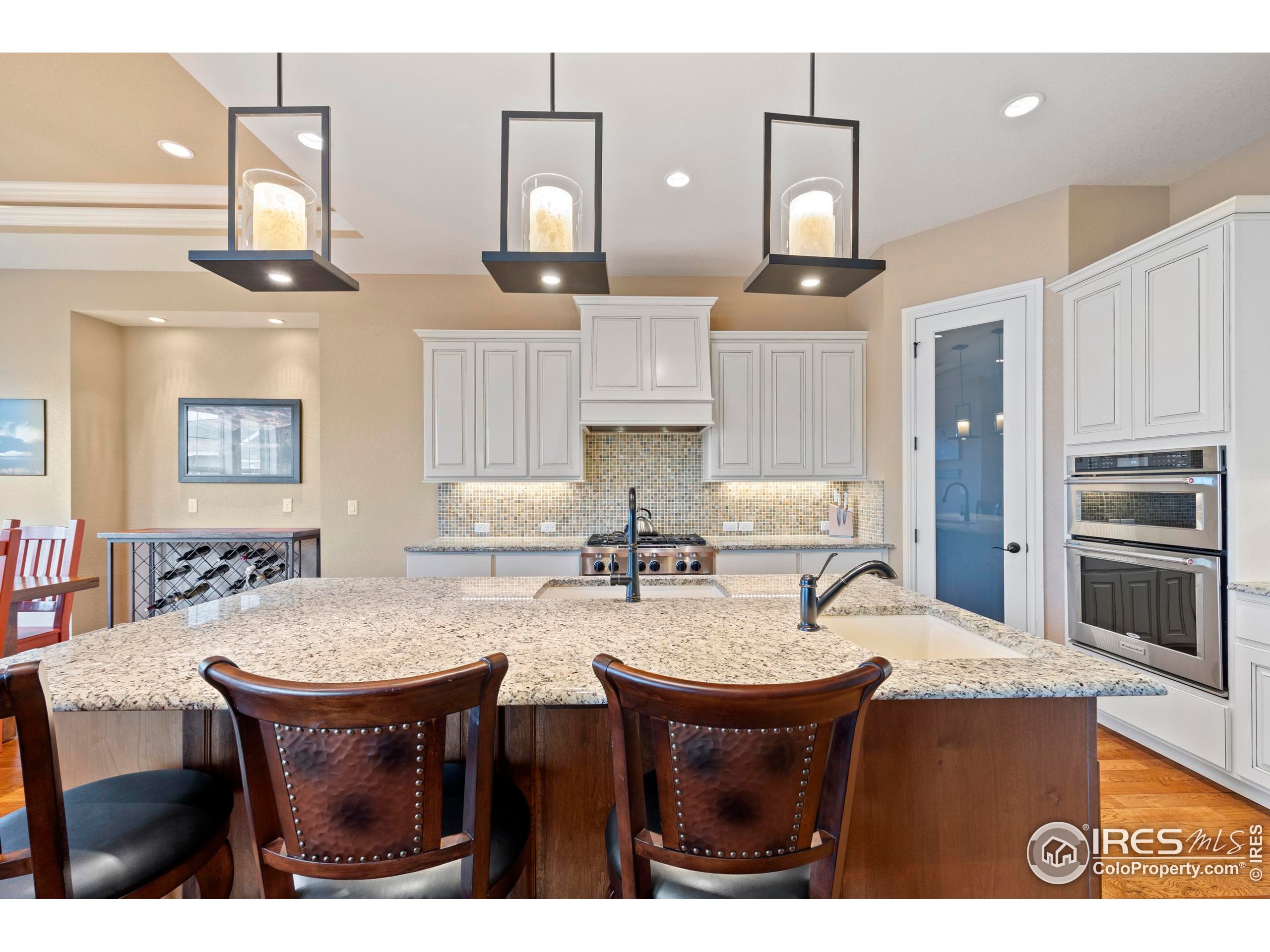 39884 Ridgecrest Court Severance, CO 80610 - Photo 14 of 44 a kitchen with cabinets and wooden floor