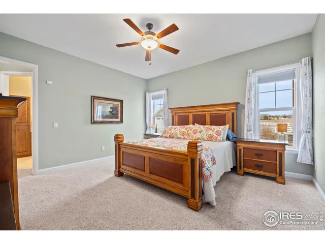 a bed room with a bed and a ceiling fan