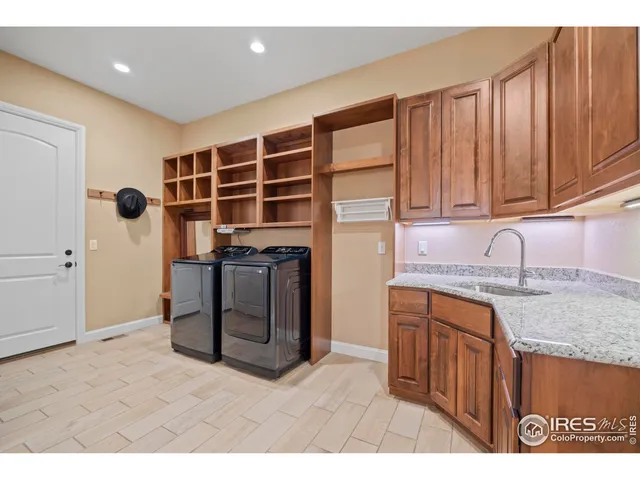 a kitchen with stainless steel appliances granite countertop a sink and a stove