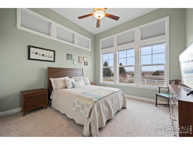 a living room with a bed furniture and a flat tv screen