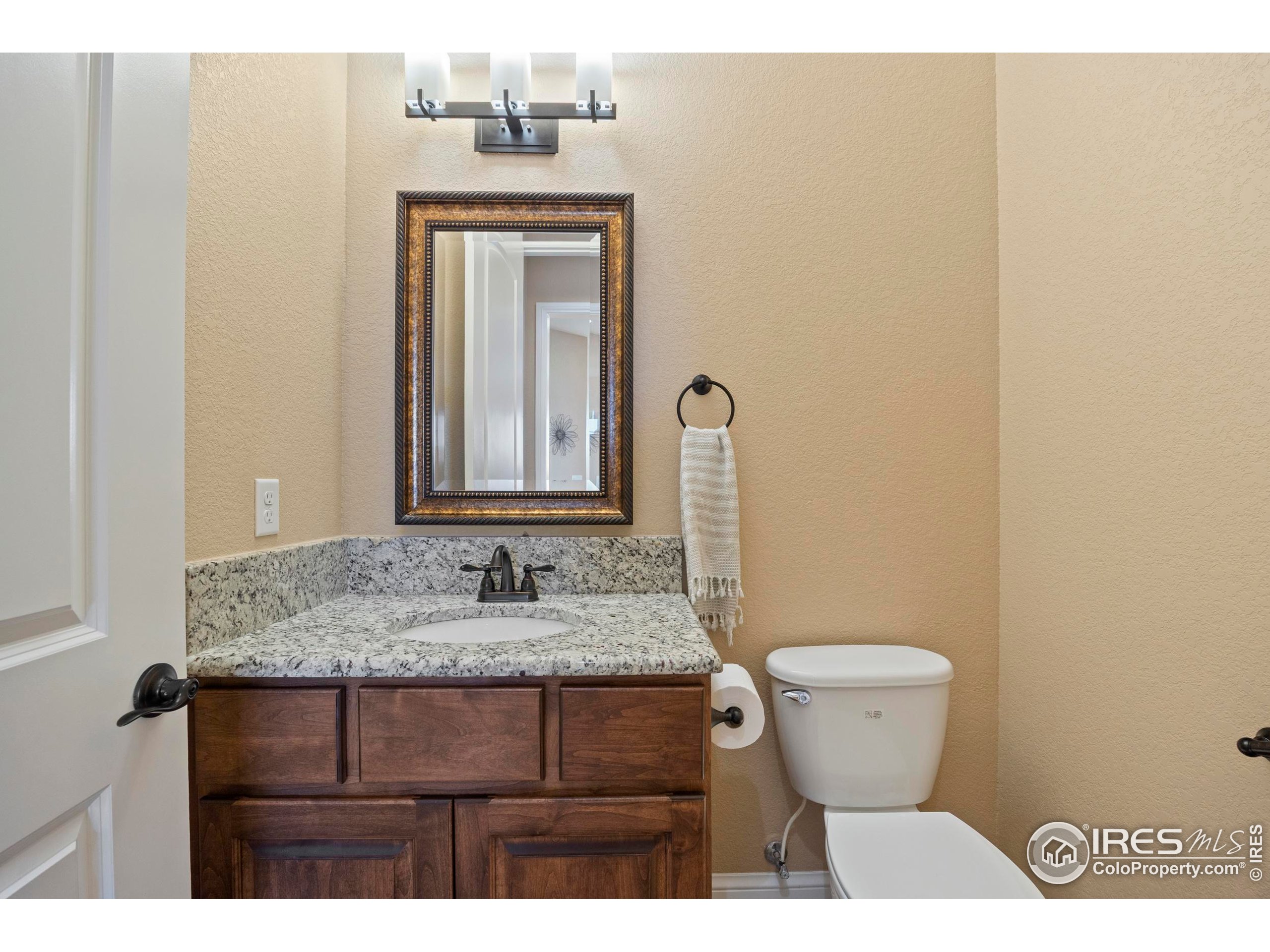 39884 Ridgecrest Court Severance, CO 80610 - Photo 25 of 44 a bathroom with a granite countertop sink and a mirror