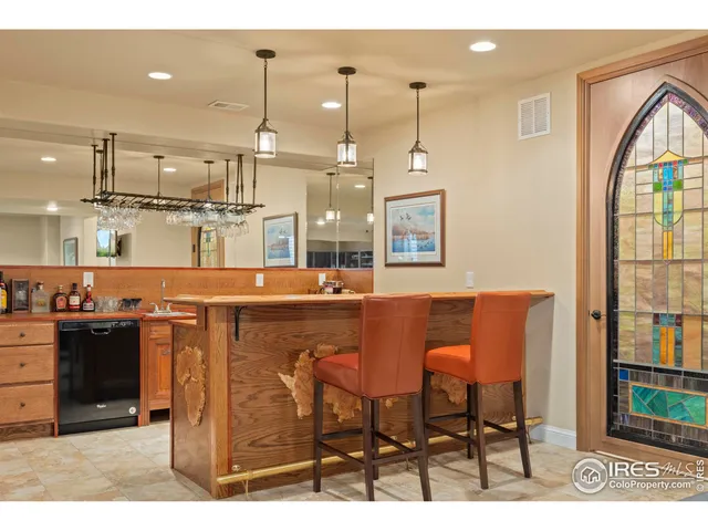 a kitchen with stainless steel appliances kitchen island granite countertop a table chairs and a view of living room