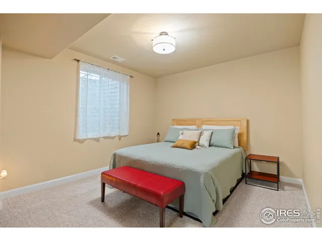 a bedroom with a bed and a night stand