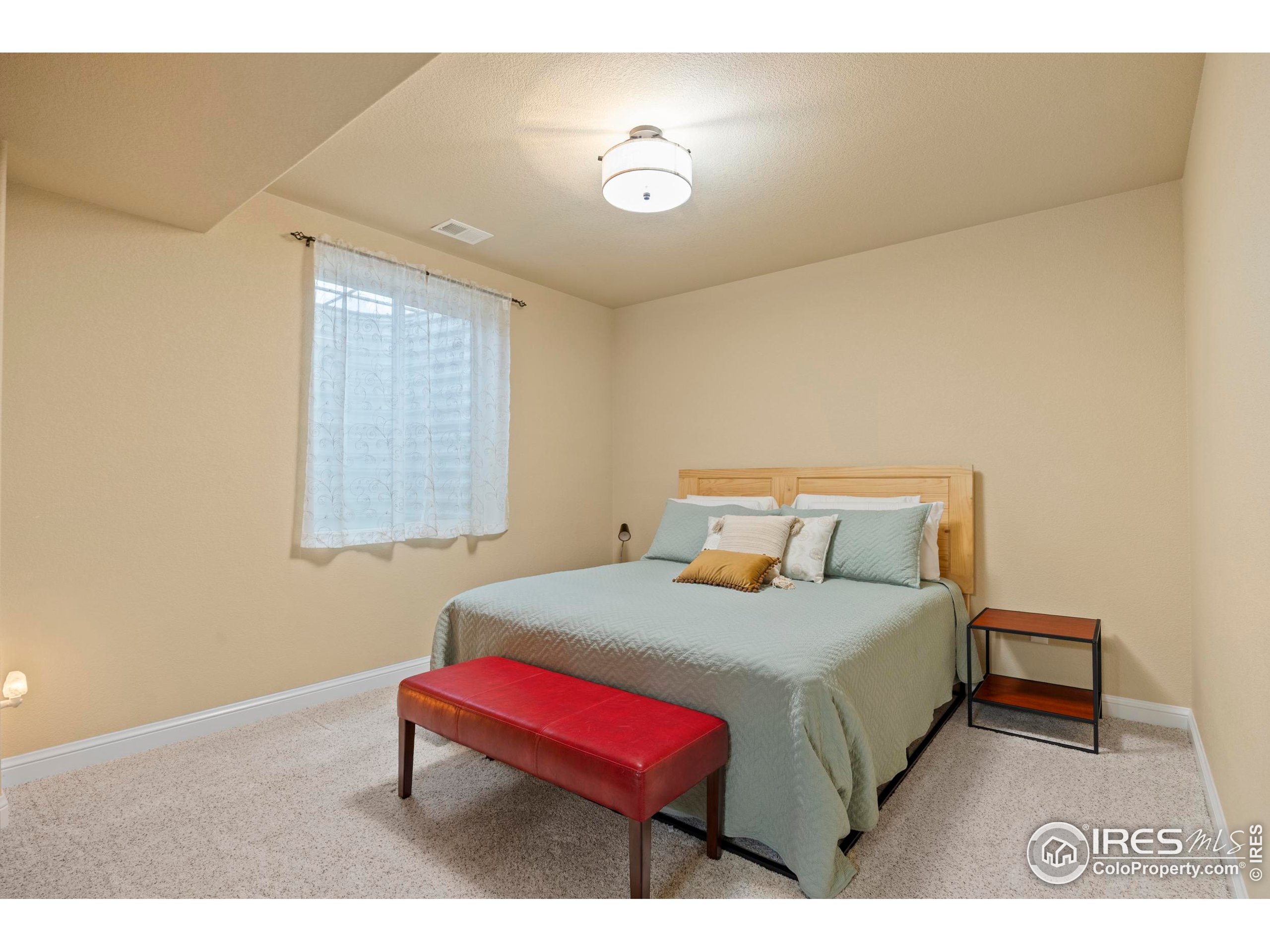 39884 Ridgecrest Court Severance, CO 80610 - Photo 30 of 44 a bedroom with a bed and a night stand