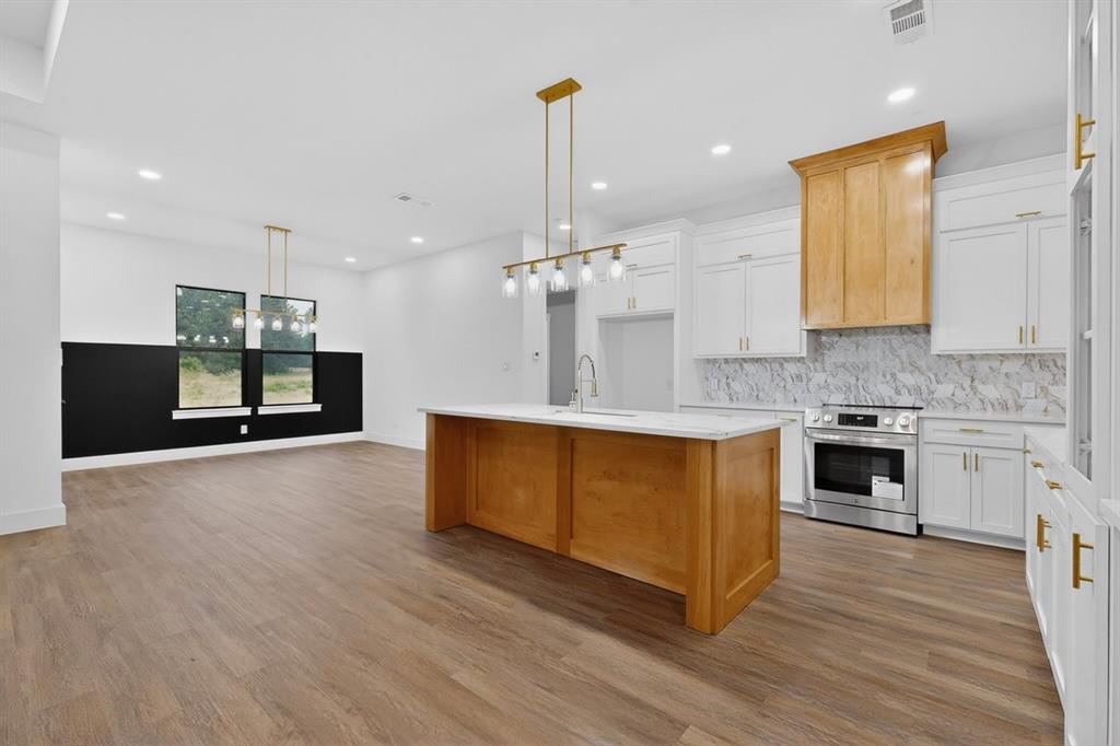 4737 Pine Ridge Court Athens, TX 75752 - Photo 8 of 26 a large kitchen with stainless steel appliances granite countertop a oven a stove and a wooden floors