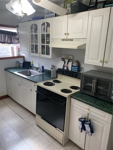 a kitchen with stainless steel appliances granite countertop a sink stove and cabinets