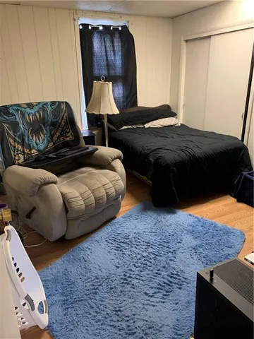 a bedroom with a bed and a couch