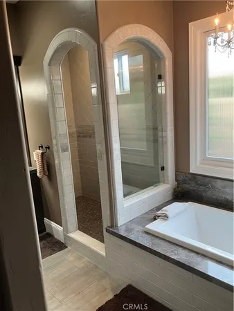 a bathroom with a tub and a glass door