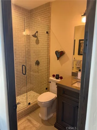 a bathroom with a toilet and a shower