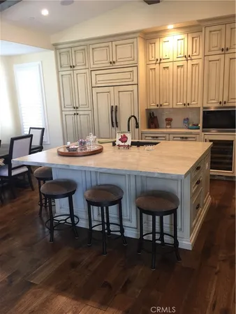 a view of a kitchen area with furniture and wooden floor