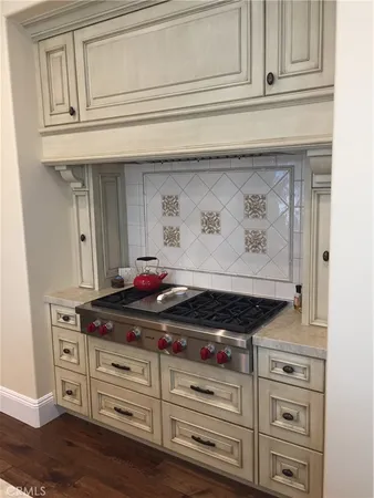 a stove top oven sitting inside of a kitchen