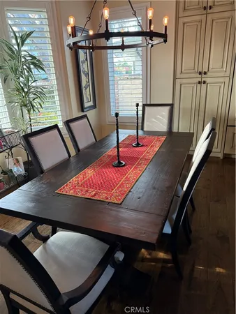 a room with furniture pool table wooden floor and window