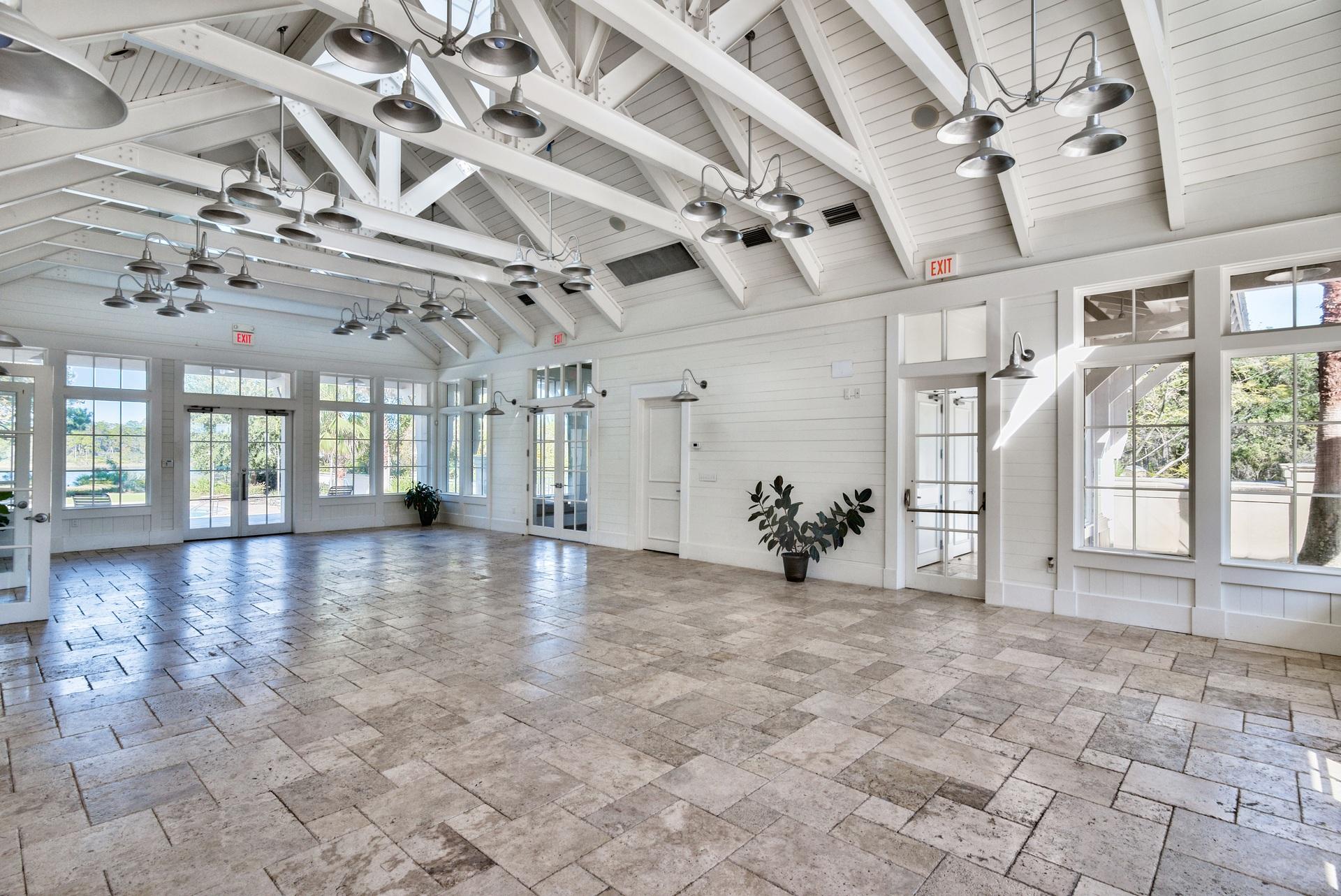 20 Inlet Cove Inlet Beach, FL 32461 - Photo 46 of 50 a view of a hall with a rug floor to ceiling windows and a chandelier