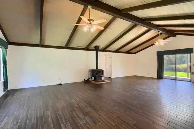 a view of a room with wooden floors and window