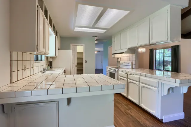 a spacious bathroom with a double vanity sink and a mirror
