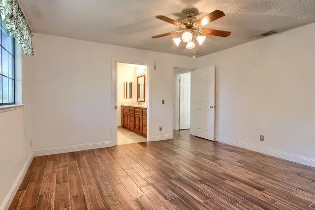 a bathroom with a granite countertop sink a toilet and shower
