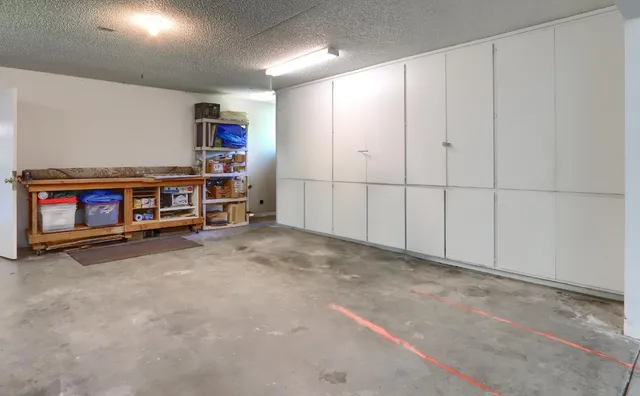 a backyard of a house with lots of plants and tree