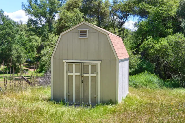 an aerial view of a house having yard and a patio