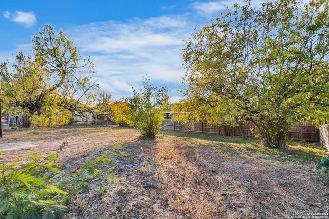 a view of a yard with swimming pool