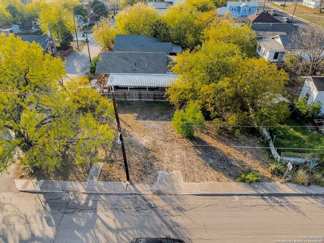 a aerial view of a house with a yard