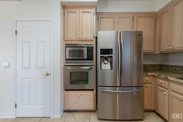 a kitchen with cabinets and stainless steel appliances