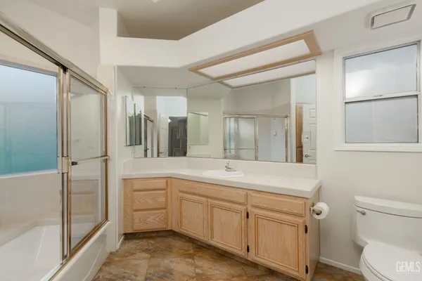 a spacious bathroom with a shower sink and mirror