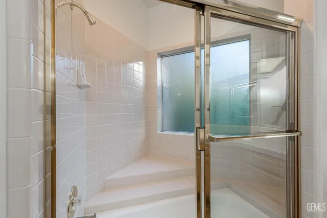 a bathroom with a glass shower door