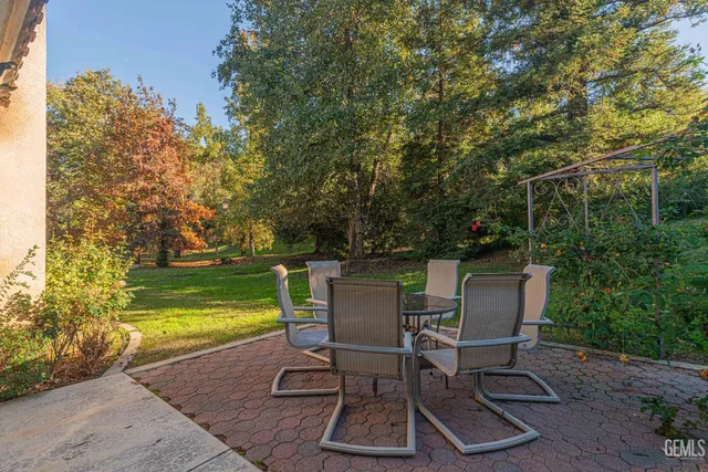 a view of a backyard with sitting area
