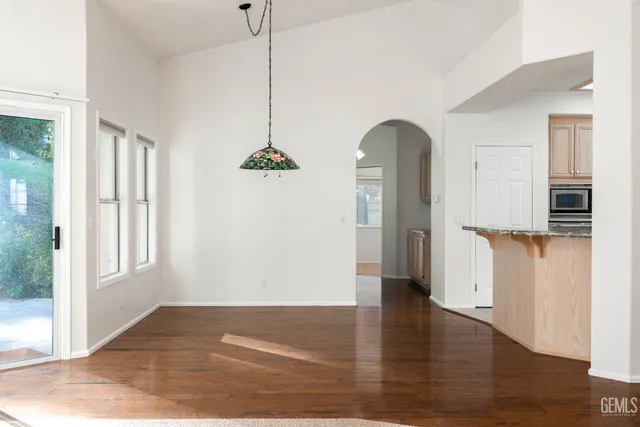 a view of a room with wooden floor and a window