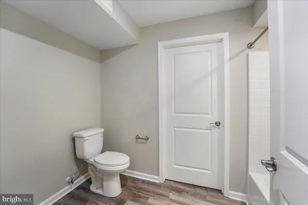 a bathroom with a toilet and a shower