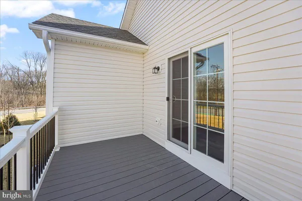 a view of a balcony with wooden floor and fence