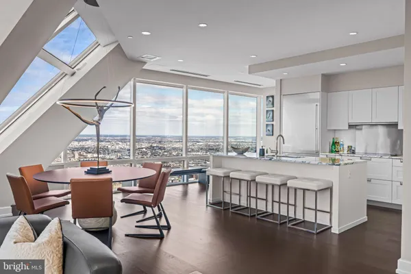 a dining room with furniture and a floor to ceiling window