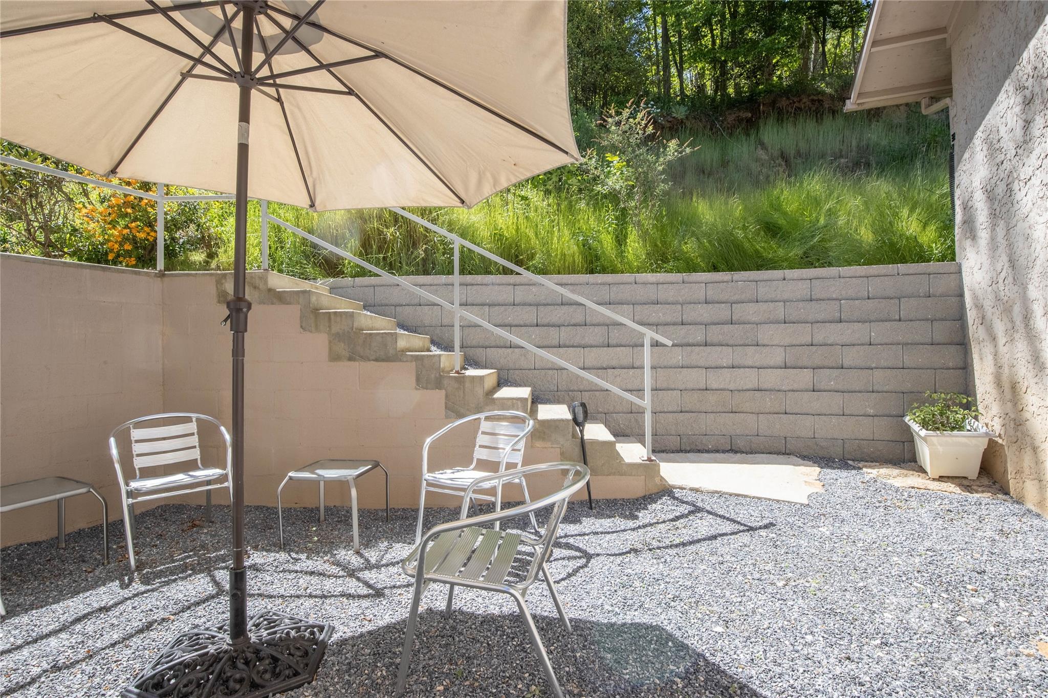 93 Franklin Crest Road Spruce Pine, NC 28777 - Photo 45 of 47 a backyard of a house with table and chairs under an umbrella
