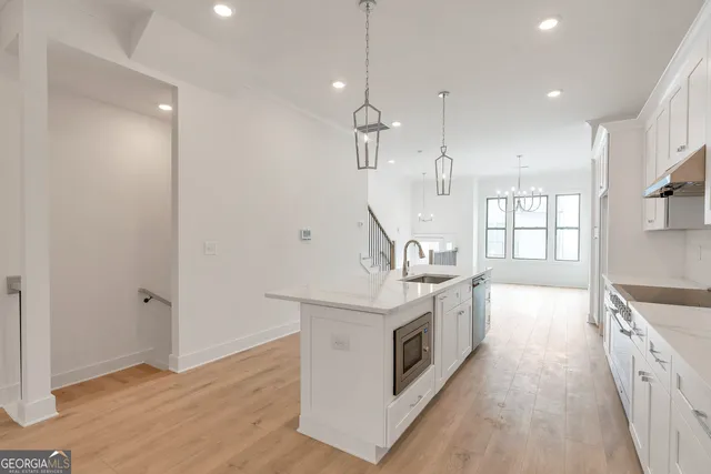 a large kitchen with a stove and a sink