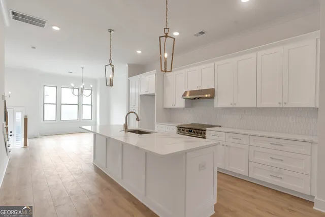 a kitchen with stove cabinets and wooden floor