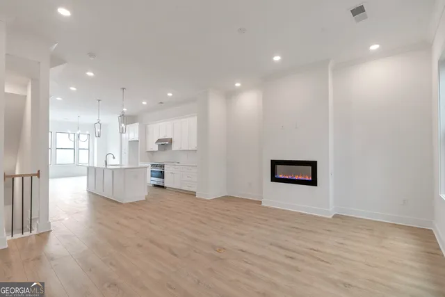a view of an empty room with wooden floor