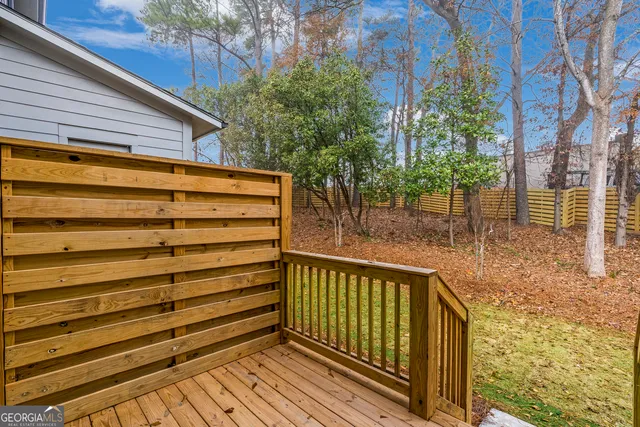 a view of a wooden fence with a tree