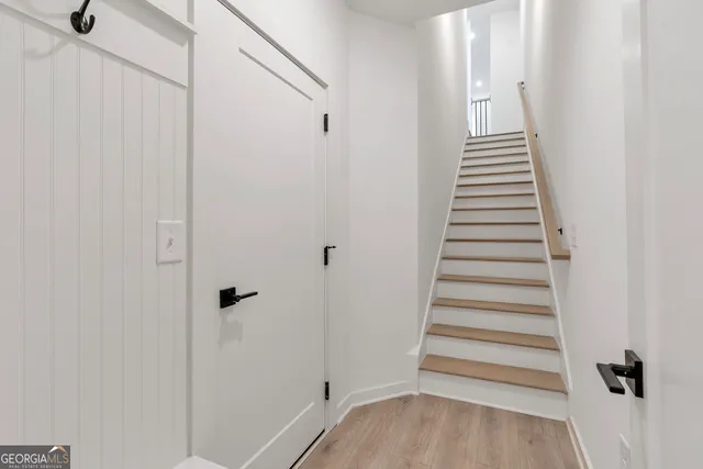 a view of a hallway with wooden floor and entryway