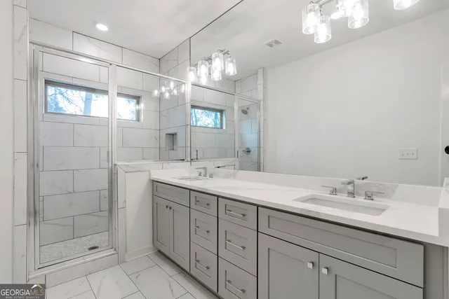 a bathroom with a sink double vanity and shower