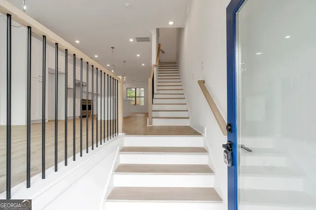 a view of entryway and hall with wooden floor
