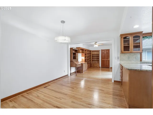 a empty room with wooden floor and window