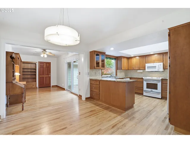 a large kitchen with a table and chairs