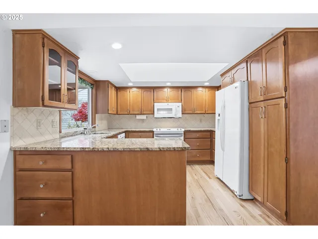 a kitchen with granite countertop a sink and cabinets