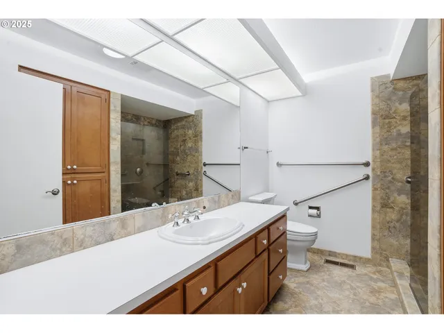 a bathroom with a sink a mirror and a toilet