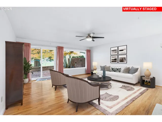 a dining room with furniture a floor to ceiling window and wooden floor