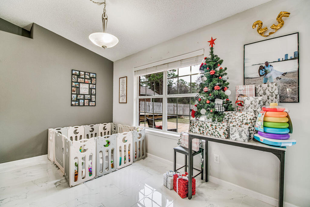 2442 Raider Lane Navarre, FL 32566 - Photo 11 of 46 a bedroom with furniture and a small space